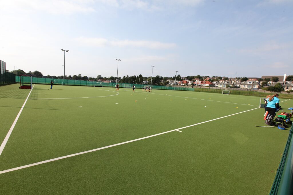 Dalnacraig. Pupils on Hockey pitch doing hockey training.