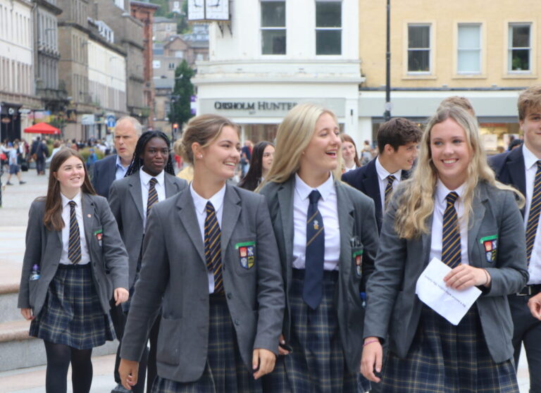 SENIOR GIRLS HEADING TO PRIZEGIVING. pupils waling through Dundee in uniform looking cheerful.