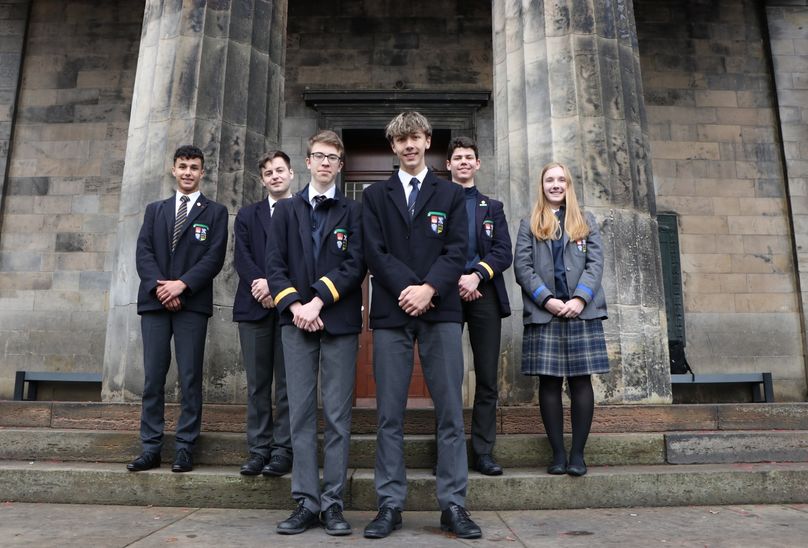 Senior Years Musical Maestros Shine featured. Pupils posing in front of school building.