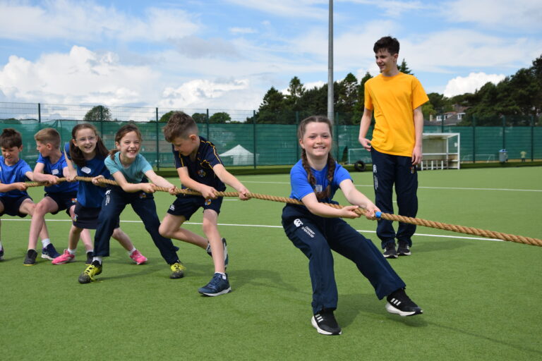 Junior Years pupils doing tug of war on astroturf at Dalnacraig