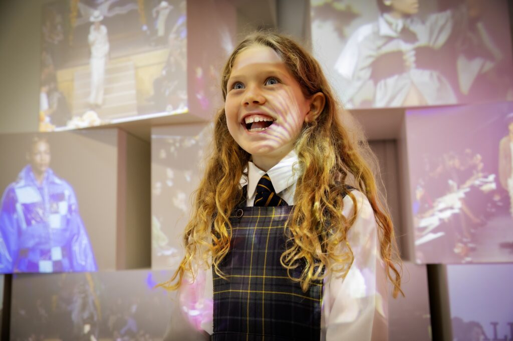 Junior Years girl with wow expression in front of projection
