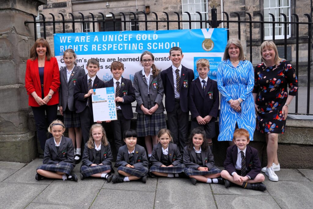 Group photo in front of RRS Gold banner