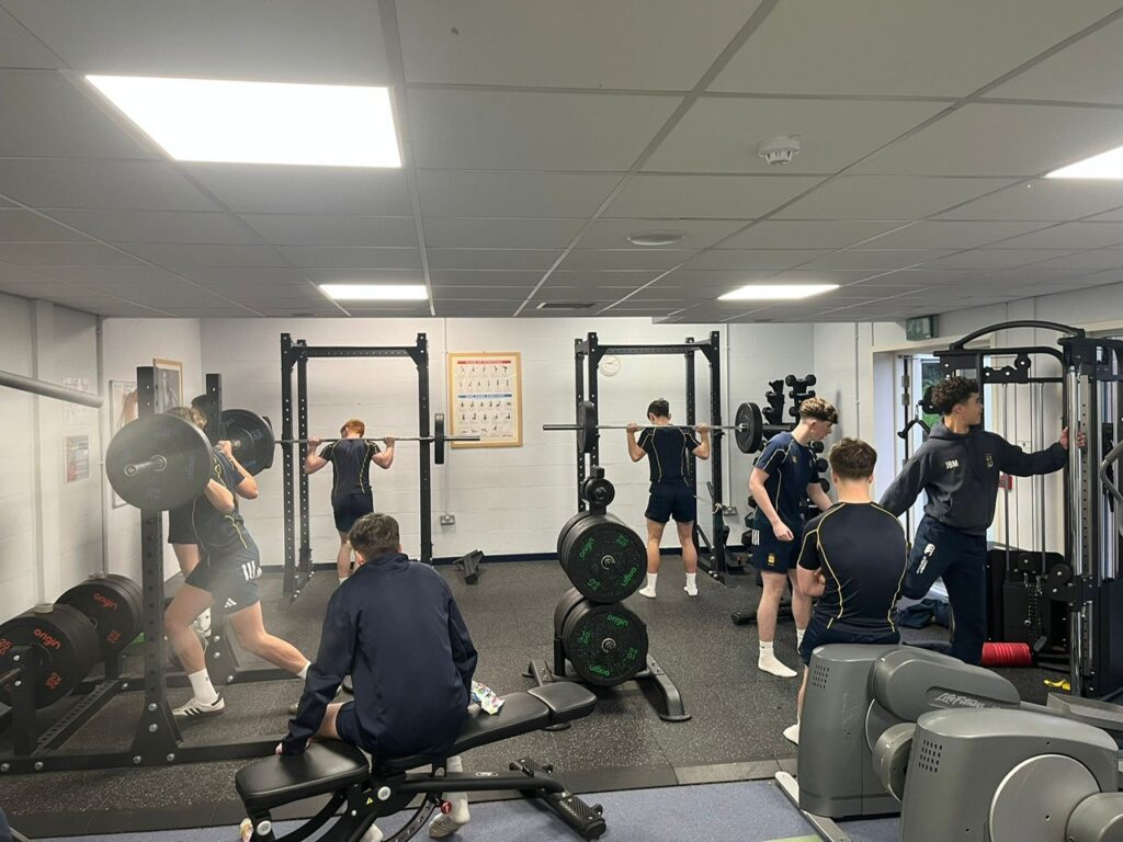 Rugby 1st XV members lifting weights in gym for Movember challenge