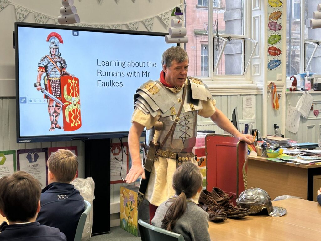 A Roam soldier standing in front of class talking about Ancient Rome