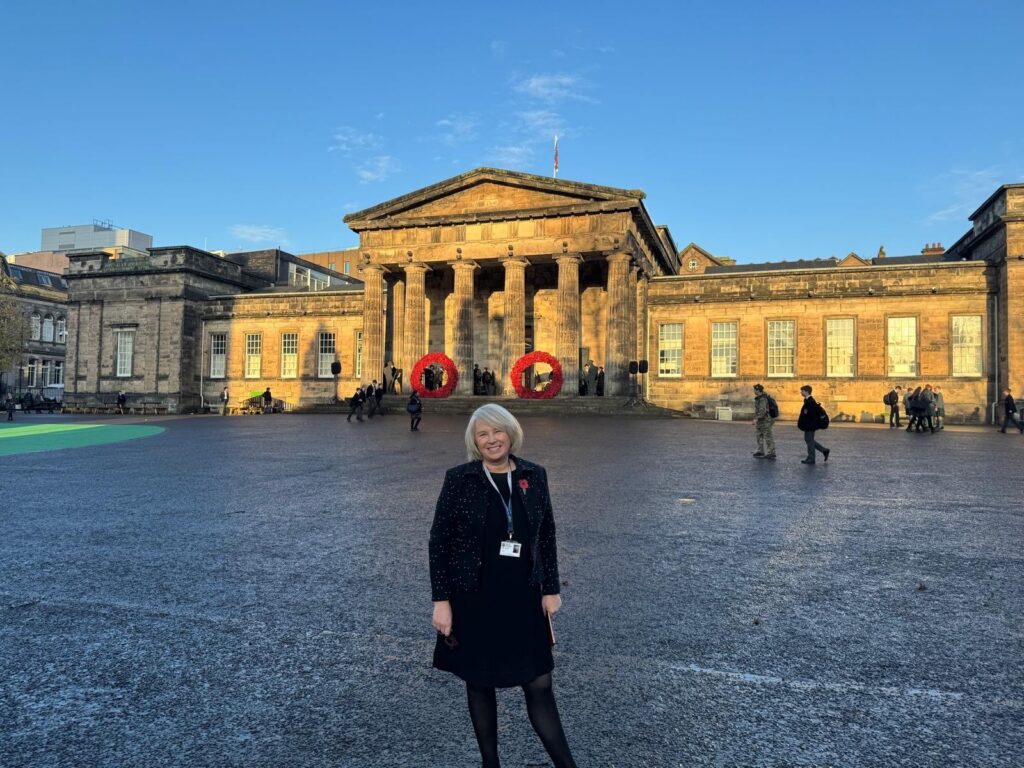 Rector Lise Hudson at bottom of playground with school Pillars behind