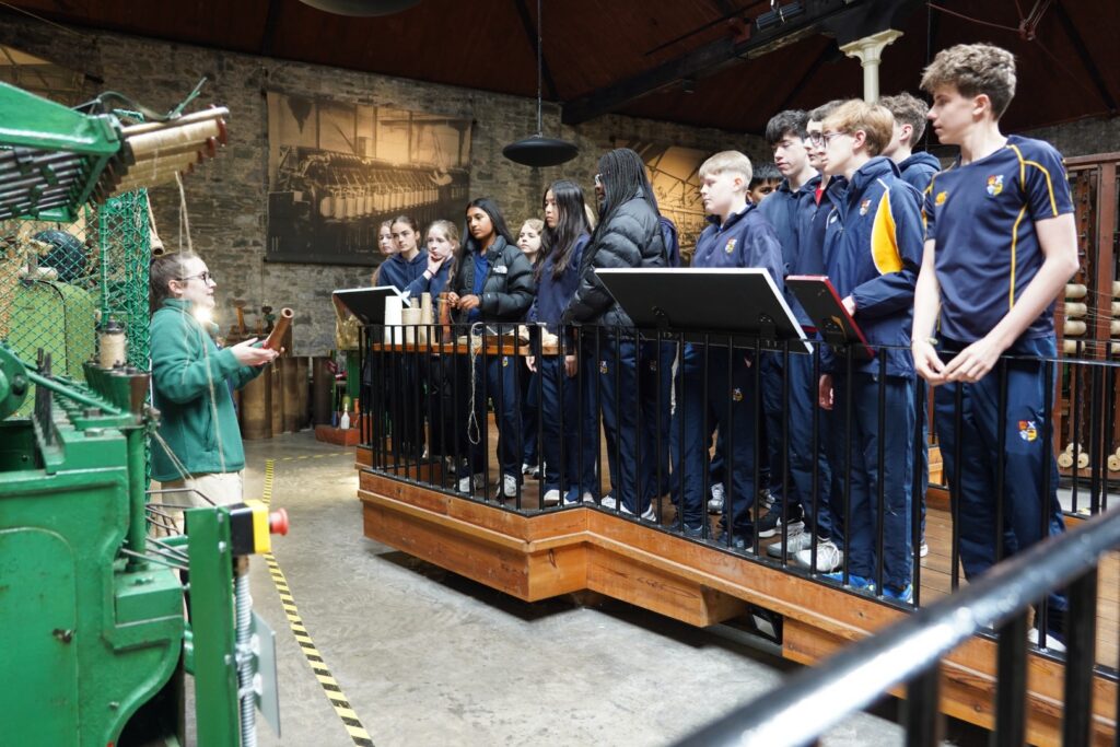 Pupils in line observing machinery at Verdant Works