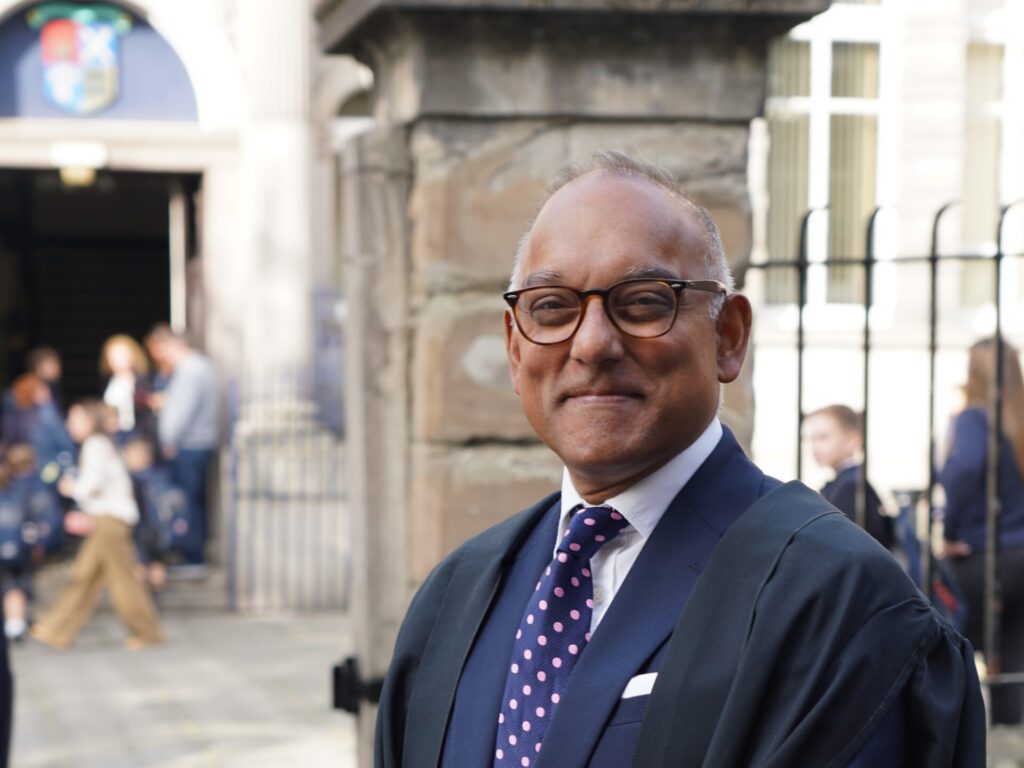 Irfan latif in front of gate at the High School of Dundee